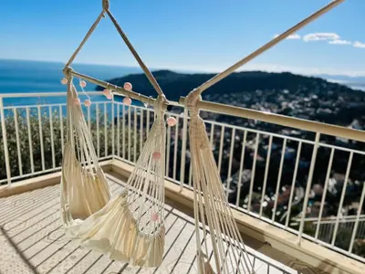 two hanging hammocks on a balcony overlooking the ocean at - Casa ATI - in Villefranche-sur-Mer
