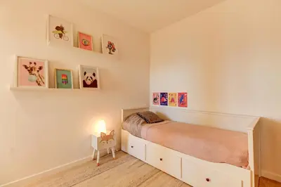 a childs bedroom with a bed and pictures on the wall at - Casa ATI - in Villefranche-sur-Mer
