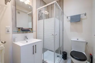 a bathroom with a glass shower and a toilet at Port de Nice - Studio with balcony in Nice