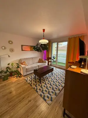 a living room with a couch and a table at AZUR DELUXE Nice in Nice