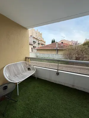 a white bench sitting on top of a balcony at AZUR DELUXE Nice in Nice