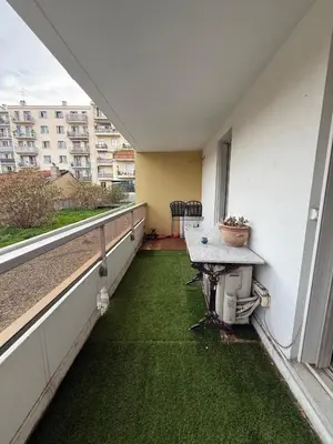 an empty balcony with a table and green grass at AZUR DELUXE Nice in Nice