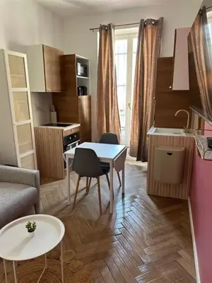 a kitchen and living room with a table and chairs at MOON 23 - Appartement Nice 2P in Nice