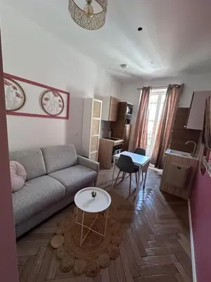 a living room with a couch and a table at MOON 23 - Appartement Nice 2P in Nice