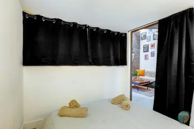 a bedroom with a large bed with two pillows at Chic Industrial Loft Quiet Garibaldi AC Balcony in Nice