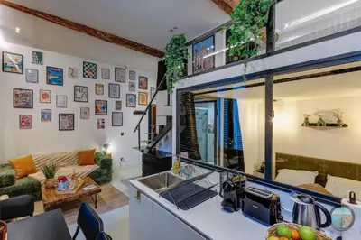 a kitchen with a sink and a living room at Chic Industrial Loft Quiet Garibaldi AC Balcony in Nice