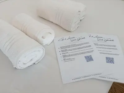 a bedroom with two towels on a bed with a window at Cozy & Lumineux Studio proche mer in Nice