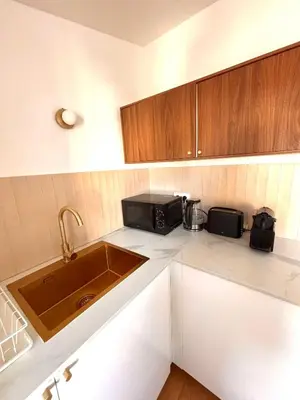 a kitchen counter with a toaster and a coffee maker at Cozy & Lumineux Studio proche mer in Nice