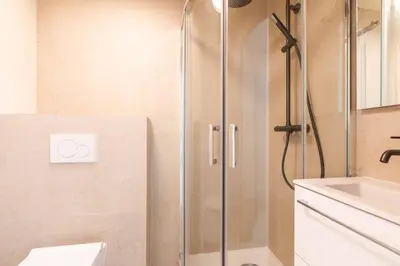 a shower with a glass door in a bathroom at Résidence So Amata , à deux pas du Port de Nice in Nice