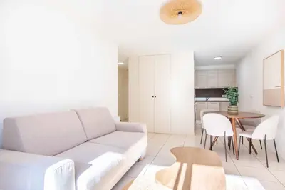 a living room with a couch and a table at Résidence So Amata , à deux pas du Port de Nice in Nice