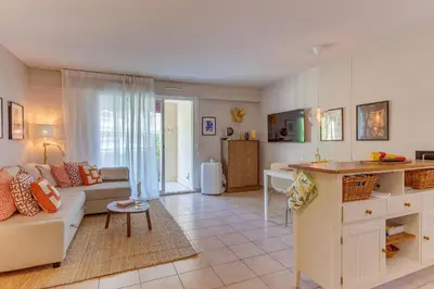 a living room with a couch and a kitchen at IMPERIA AP4490 by RIVIERA HOLIDAY HOMES in Nice