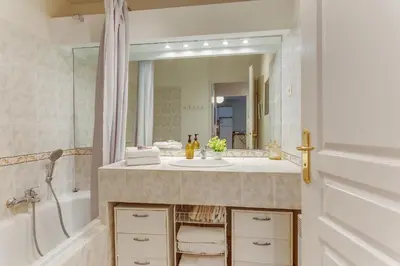 a bathroom with a sink and a tub and a mirror at IMPERIA AP4490 by RIVIERA HOLIDAY HOMES in Nice