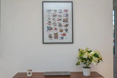 a picture on a wall with a table and a plant at Quartier Libération - La Vie à la Niçoise in Nice