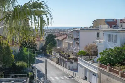 a city street with a palm tree and buildings at Quartier Libération - La Vie à la Niçoise in Nice