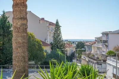 a city street with a palm tree and buildings at Quartier Libération - La Vie à la Niçoise in Nice