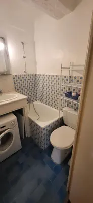 a bathroom with a toilet and a tub and a sink at Nice Plage in Nice
