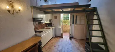 a kitchen with a ladder in the middle of a kitchen at Nice Plage in Nice
