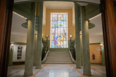 a hallway with a staircase with a stained glass window at Appartement-Suite neuf - 2 chambres - 1 min mer in Nice