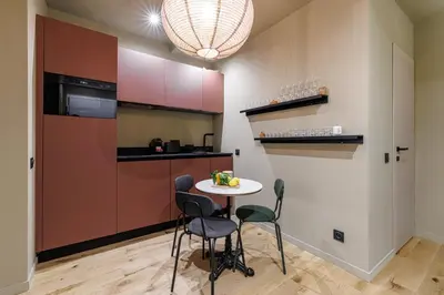 a small kitchen with a small table and chairs at Wonderful Stay close to Garibaldi - Aircon in Nice
