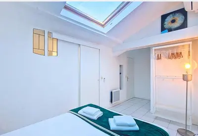a bedroom with a bed and a skylight at Nestor&Jeeves - L ESCURIAL - Central in Nice