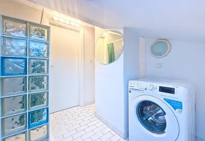 a laundry room with a washing machine and a mirror at Nestor&Jeeves - L ESCURIAL - Central in Nice