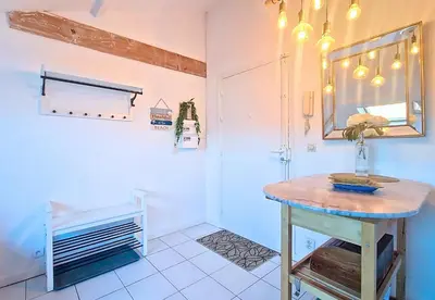 a bathroom with a table and a mirror in a room at Nestor&Jeeves - L ESCURIAL - Central in Nice