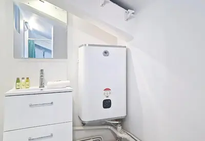 a white bathroom with a toilet and a sink at Nestor&Jeeves - L ESCURIAL - Central in Nice