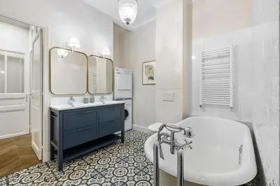 a bathroom with a tub and a sink and a mirror at Nice Renting - AMOUR - Haussmann Luxury Sea Balcony Free Parking in Nice