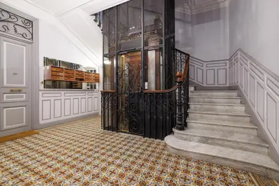 a hallway with a staircase with a large door at Nice Renting - AMOUR - Haussmann Luxury Sea Balcony Free Parking in Nice