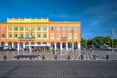 a large yellow building with people walking in front of it at Emplacement exceptionnel Deux Chambres AC WIFI in Nice