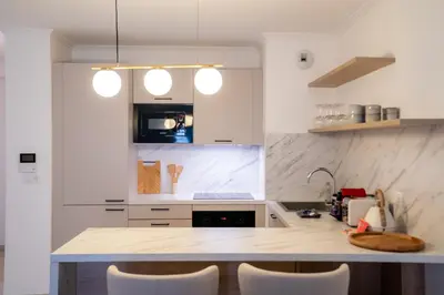 a kitchen with a counter with chairs in it at T3 résidence neuve Centre-Ville 6 Couchages in Nice