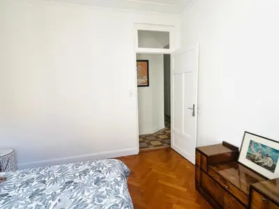 a white room with a bed and a door at 2P de charme proche gare et hyper centre Nice in Nice