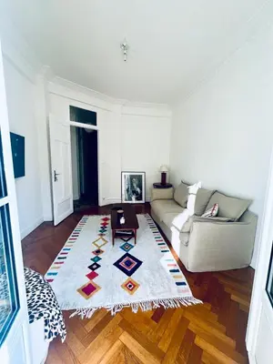 a living room with a couch and a rug at 2P de charme proche gare et hyper centre Nice in Nice