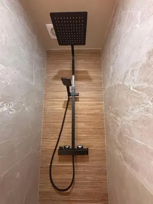 a shower in a bathroom with a hair dryer on the floor at Atelier de Lumière Nice Gambetta in Nice