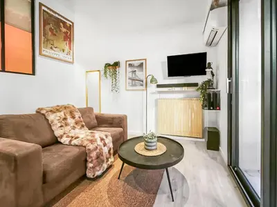 a living room with a couch and a table at Central, élégant & cosy in Nice
