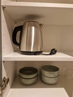 a tea kettle and bowls on a shelf in a kitchen at Alex&Chris in Nice