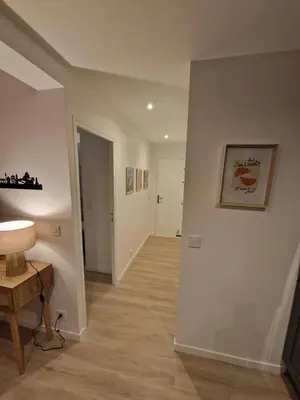 a room with a hallway with a table and a lamp at Alex&Chris in Nice