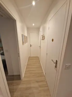 a hallway with a white door and a wooden floor at Alex&Chris in Nice