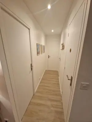 a hallway with white doors and a wooden floor at Alex&Chris in Nice