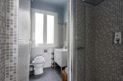 a bathroom with a toilet and a window at La Suite Londres in Nice