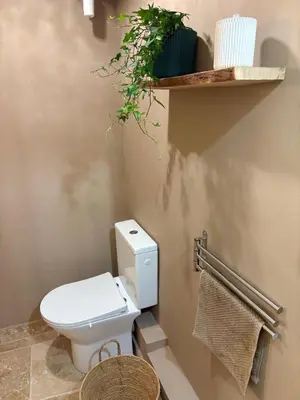 a bathroom with a white toilet and a shelf at Authentic Provençal Studio in Nice