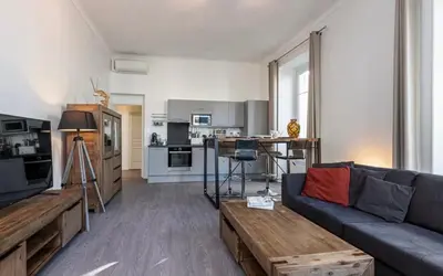 a living room with a couch and a table at Appartement 2 chambres Nice Jean Medecin in Nice