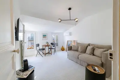 a living room with a couch and a table at Charming Ultra Central 1 Bdr in Nice