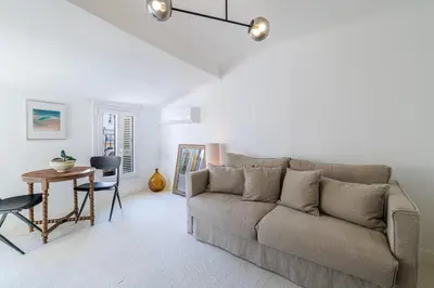 a living room with a couch and a table at Charming Ultra Central 1 Bdr in Nice