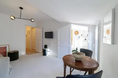 a living room with a table with a plant on it at Charming Ultra Central 1 Bdr in Nice