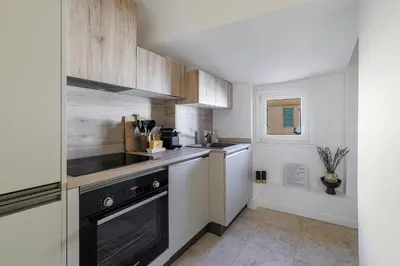 a small kitchen with a sink and a stove at Charming Ultra Central 1 Bdr in Nice
