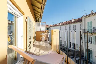 a balcony with a table and chairs on it at Charming Ultra Central 1 Bdr in Nice