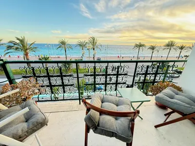 a balcony with chairs and a view of the beach at Casa Giacometti Vue Mer Lumiere et Horizon in Nice
