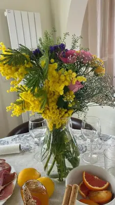 a vase filled with flowers sitting on a table at Casa Giacometti Vue Mer Lumiere et Horizon in Nice