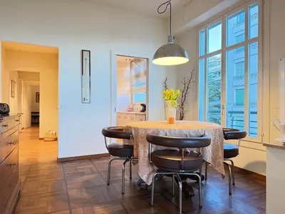 a kitchen and dining room with a table and chairs at Casa Giacometti Vue Mer Lumiere et Horizon in Nice